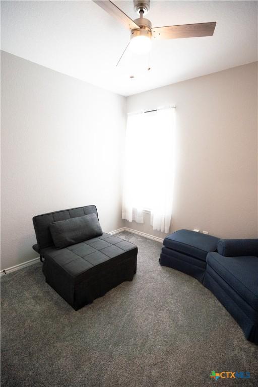 7709 Purvis St, Temple, TX 76502 - living area featuring carpet floors, a ceiling fan, and baseboards