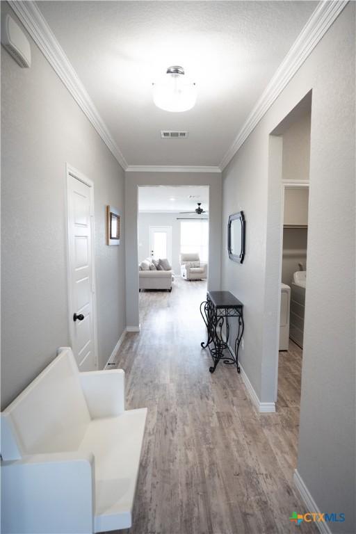 7709 Purvis St, Temple, TX 76502 - hallway with wood finished floors, crown molding, and baseboards