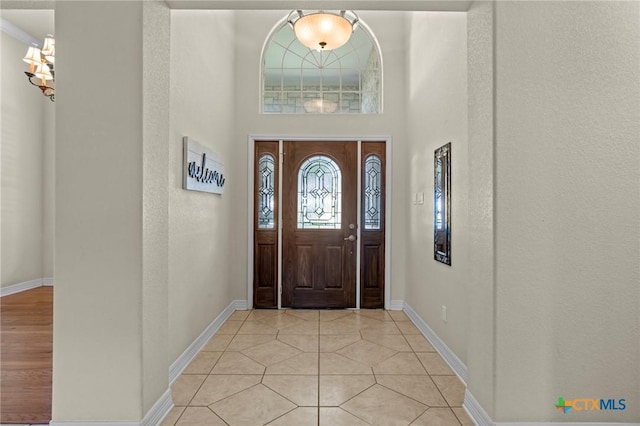 402 Prospector Trl, Harker Heights, TX 76548 - entrance foyer with a chandelier, light tile patterned floors, and a towering ceiling
