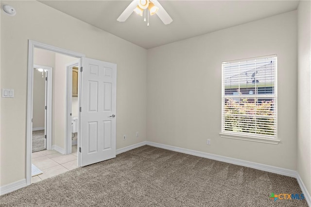 402 Prospector Trl, Harker Heights, TX 76548 - unfurnished bedroom featuring light colored carpet, light tile patterned floors, and ceiling fan