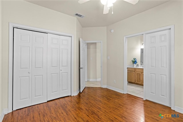402 Prospector Trl, Harker Heights, TX 76548 - unfurnished bedroom featuring a closet, light wood-style floors, ceiling fan, and connected bathroom
