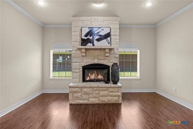 402 Prospector Trl, Harker Heights, TX 76548 - unfurnished living room featuring a stone fireplace, dark wood-style flooring, ornamental molding, and recessed lighting