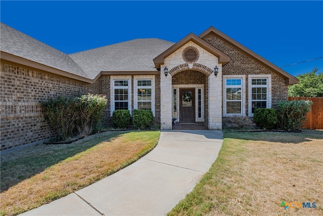 view of exterior entry with a yard