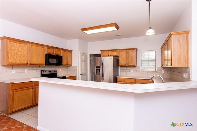 212 Oak Ridge Dr, Nolanville, TX 76559 - kitchen featuring light tile patterned floors, visible vents, a peninsula, light countertops, and appliances with stainless steel finishes