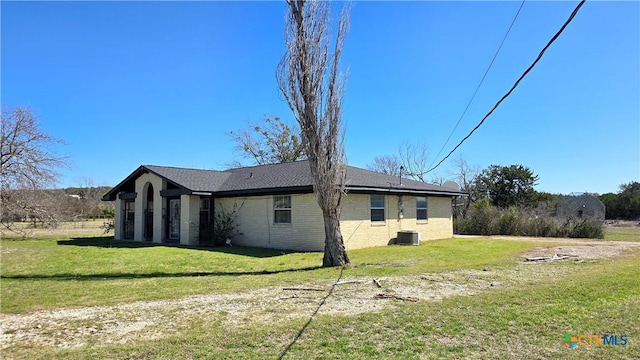 view of home's exterior featuring a lawn and brick siding