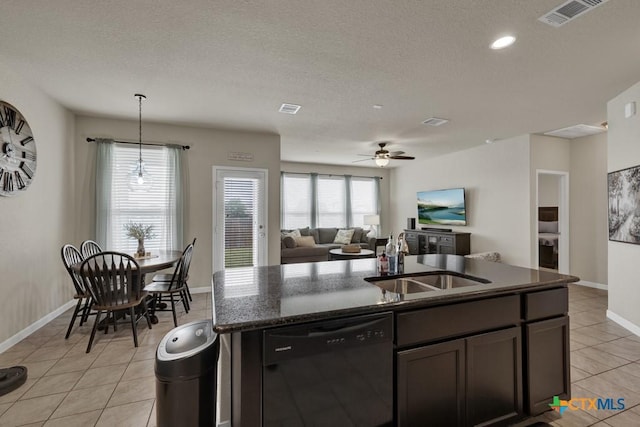 1398 Fall Cover St, New Braunfels, TX 78130 - kitchen with black dishwasher, light tile patterned floors, a kitchen island with sink, a ceiling fan, and open floor plan