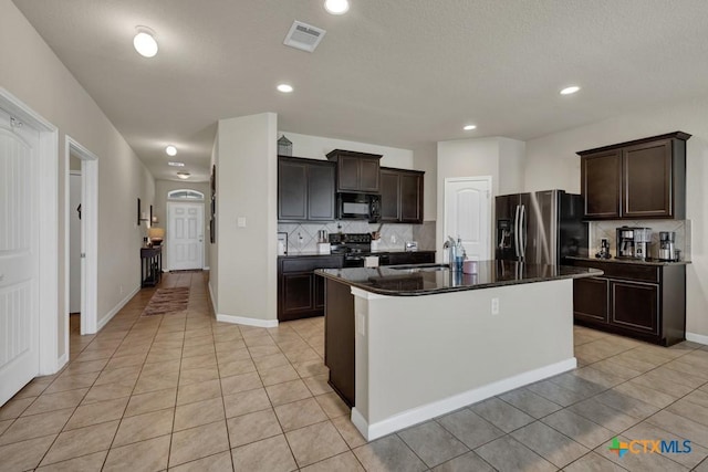 1398 Fall Cover St, New Braunfels, TX 78130 - kitchen featuring black appliances, decorative backsplash, dark countertops, light tile patterned floors, and recessed lighting