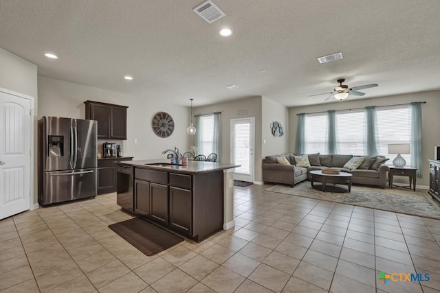 1398 Fall Cover St, New Braunfels, TX 78130 - kitchen featuring stainless steel fridge, dishwasher, dark brown cabinetry, a textured ceiling, and open floor plan
