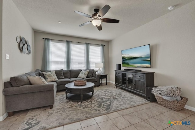 1398 Fall Cover St, New Braunfels, TX 78130 - living area with a ceiling fan, light tile patterned flooring, and a textured ceiling