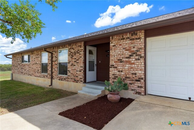 doorway to property featuring a garage