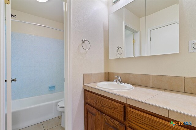 full bathroom with tile patterned flooring, vanity, toilet, and shower / washtub combination