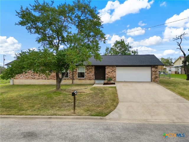 view of front facade with a garage and a front lawn