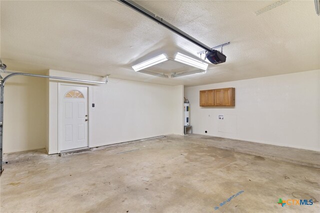 garage featuring a garage door opener and water heater