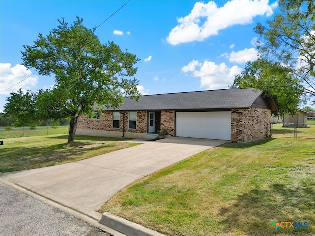 ranch-style home featuring a front lawn and a garage