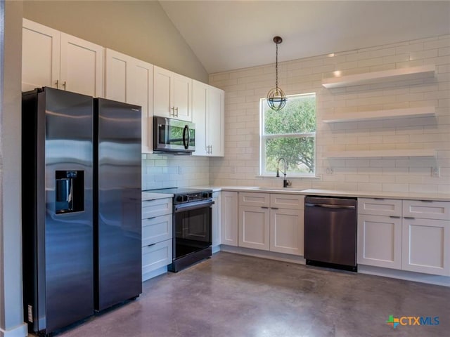 kitchen with appliances with stainless steel finishes, sink, hanging light fixtures, and white cabinets