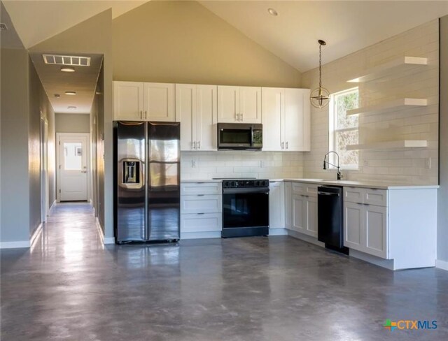 kitchen featuring white cabinetry, tasteful backsplash, hanging light fixtures, and black appliances