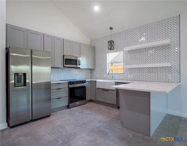 307 Cedarhill Dr, Granite Shoals, TX 78654 - kitchen with light countertops, appliances with stainless steel finishes, a peninsula, gray cabinets, and lofted ceiling