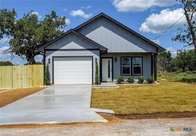 view of front of house with a garage and a front yard