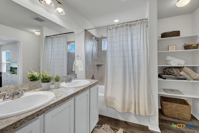 2328 Arctic Warbler, New Braunfels, TX 78130 - bathroom featuring shower / bath combo with shower curtain, wood finished floors, and double vanity