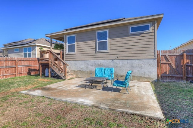 2328 Arctic Warbler, New Braunfels, TX 78130 - rear view of house featuring roof mounted solar panels, a patio area, stairs, and a gate