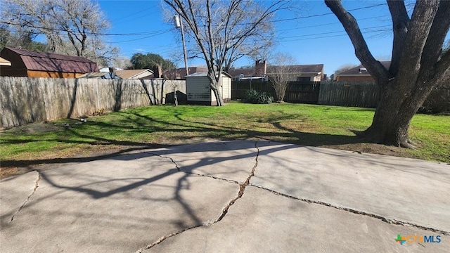 view of yard featuring a storage shed and a patio area