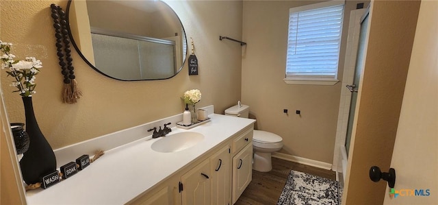 full bathroom featuring shower / bath combination with glass door, vanity, toilet, and hardwood / wood-style floors