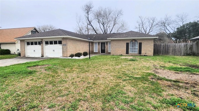 ranch-style home with a garage and a front yard