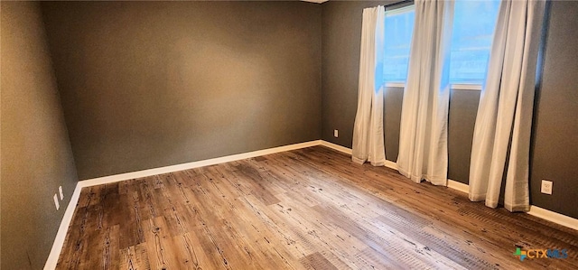 unfurnished room featuring hardwood / wood-style flooring