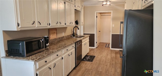 kitchen with stone counters, white cabinetry, stainless steel appliances, crown molding, and light hardwood / wood-style flooring