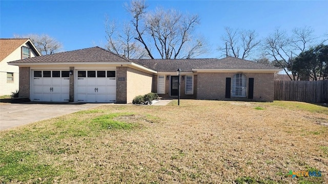 ranch-style house featuring a garage and a front lawn