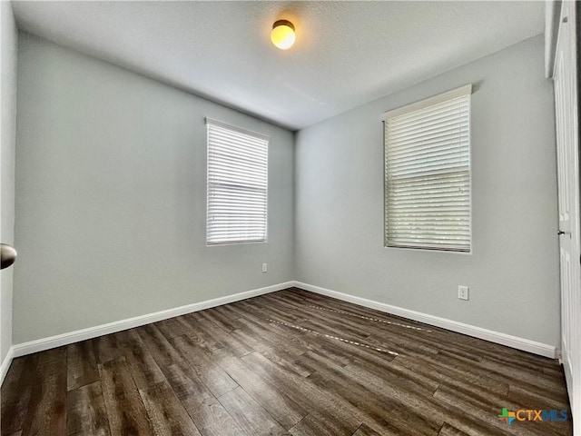 110 Rush Hvn, San Marcos, TX 78666 - unfurnished room featuring baseboards and dark wood-style floors
