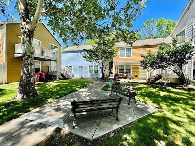 110 Rush Hvn, San Marcos, TX 78666 - back of property featuring a yard, stairs, and a patio area