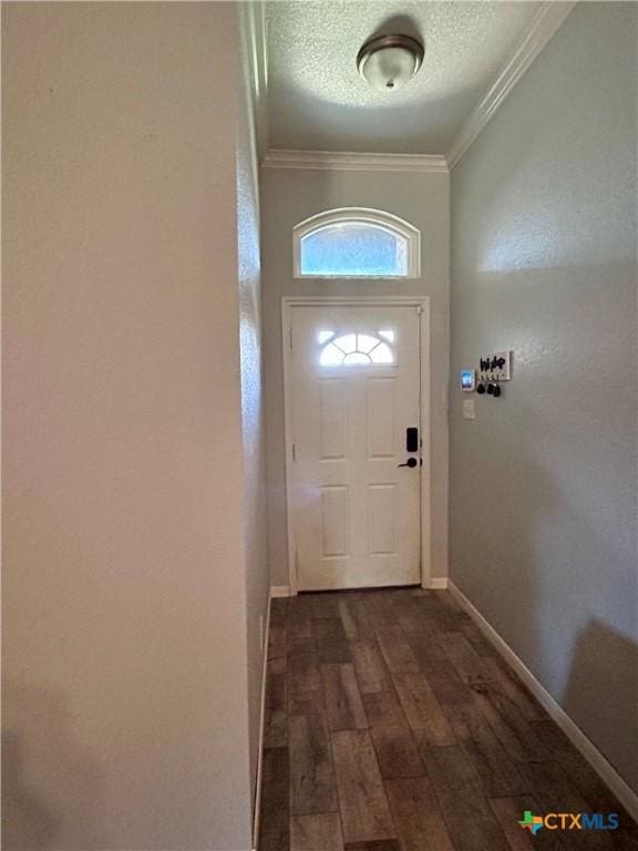 entryway with crown molding, dark hardwood / wood-style floors, and a textured ceiling