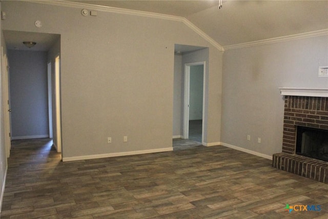 unfurnished living room featuring crown molding, dark hardwood / wood-style floors, vaulted ceiling, and a brick fireplace