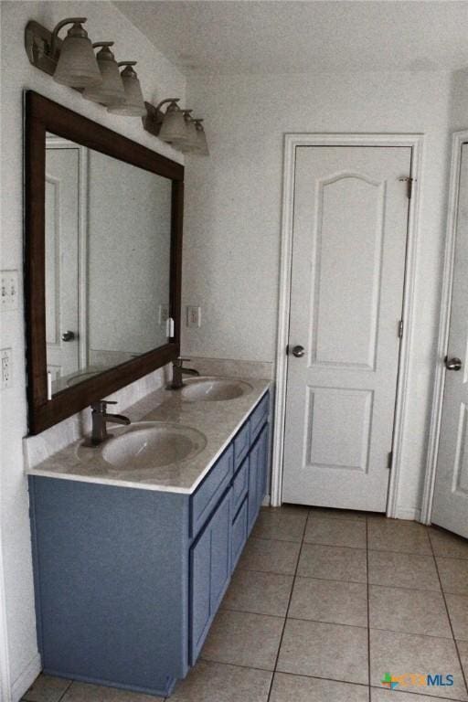 bathroom with tile patterned floors and vanity