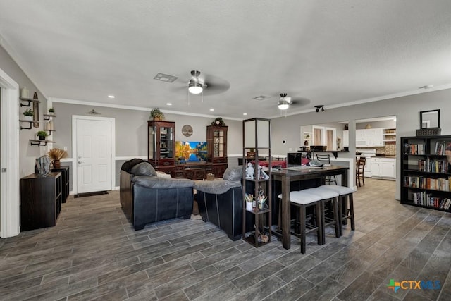 332 W Klein St, Seguin, TX 78155 - living area with ceiling fan, ornamental molding, wood finished floors, and recessed lighting