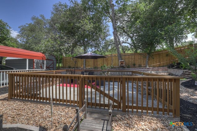 332 W Klein St, Seguin, TX 78155 - deck featuring a fenced backyard and a storage unit