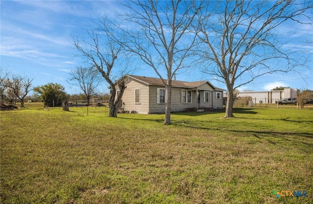 view of side of property with a yard