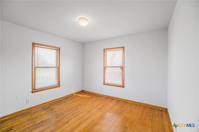 unfurnished room with wood-type flooring