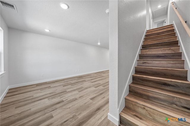 1009 S 26th St, Temple, TX 76501 - stairway featuring wood finished floors, baseboards, and recessed lighting