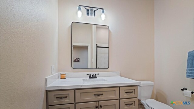 bathroom with vanity and toilet