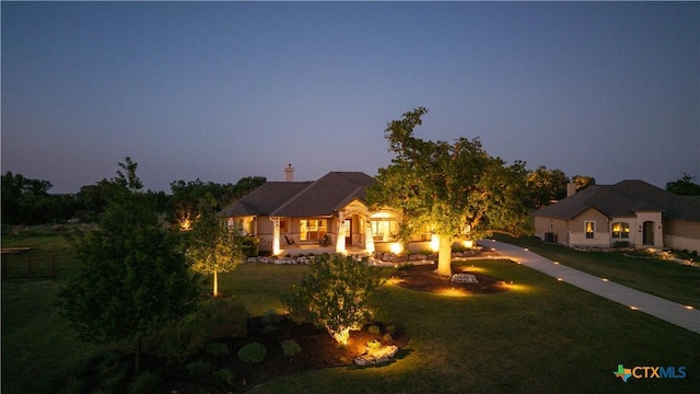 view of front facade featuring a front lawn and a fire pit