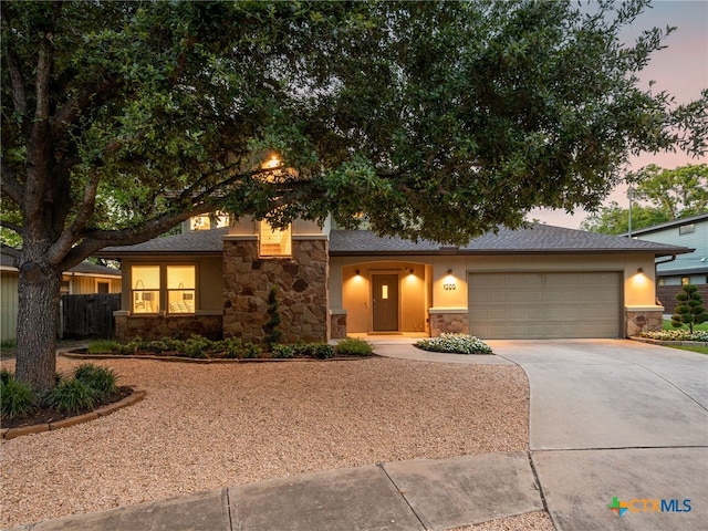 1200 Marcy St, Austin, TX 78745 - view of front of property with stone siding, driveway, a garage, stucco siding, and a shingled roof