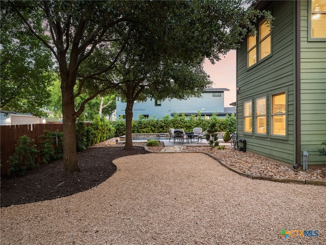 1200 Marcy St, Austin, TX 78745 - yard at dusk with a patio