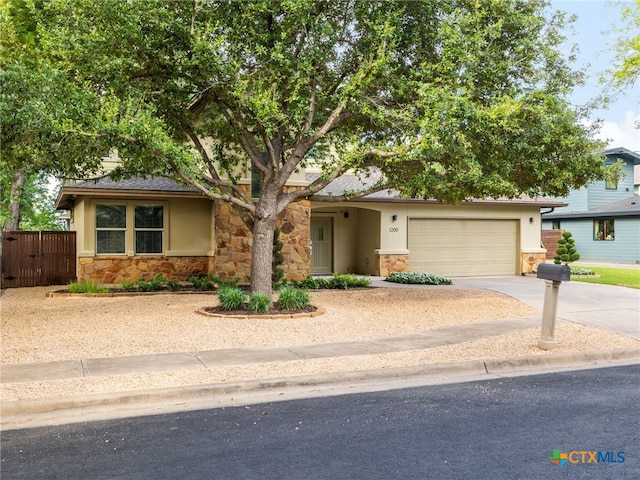 1200 Marcy St, Austin, TX 78745 - view of front facade featuring stone siding, driveway, and stucco siding