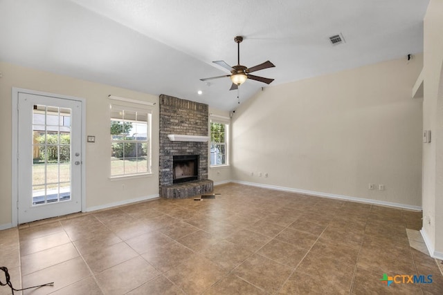 unfurnished living room with light tile patterned flooring, ceiling fan, vaulted ceiling, and a brick fireplace