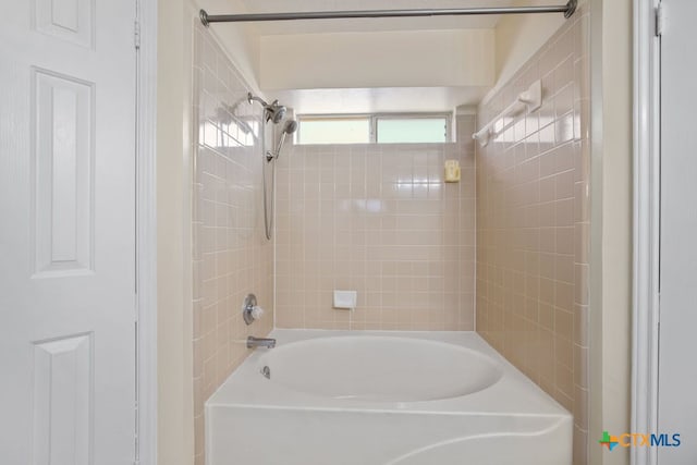 bathroom featuring vanity, hardwood / wood-style floors, and tiled shower / bath