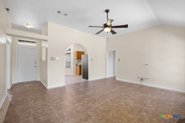 interior space with lofted ceiling, tile patterned floors, and ceiling fan