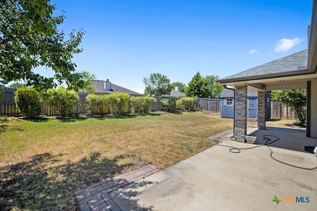 view of yard featuring a storage shed and a patio