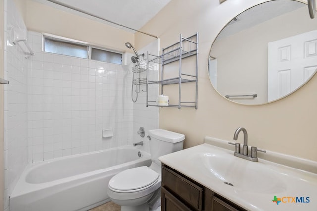 full bathroom featuring tiled shower / bath combo, vanity, and toilet